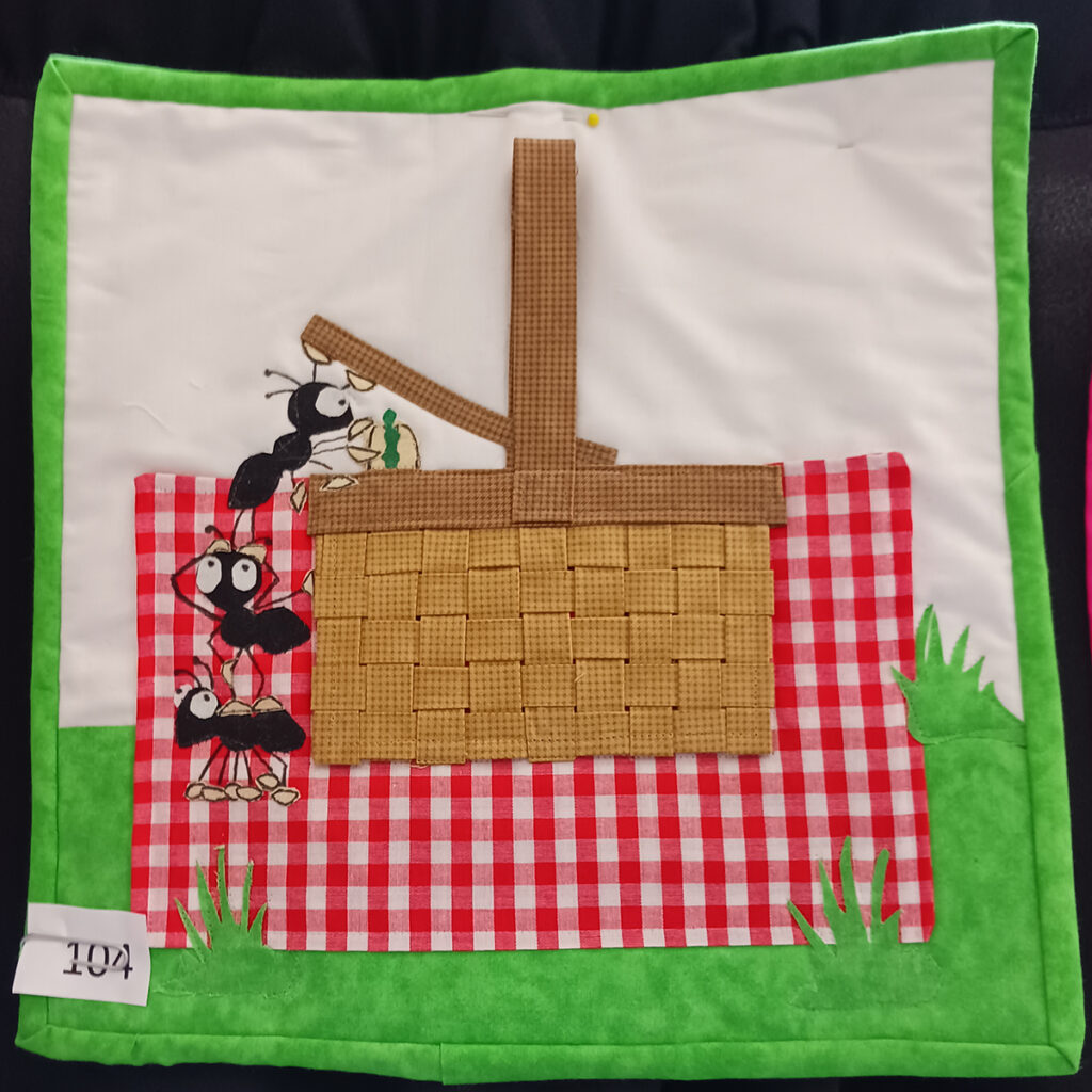 The Quilt Square Auction Viewer’s Choice was this 3-D picnic basket with ants, created by Margo Couch of Wayne County.